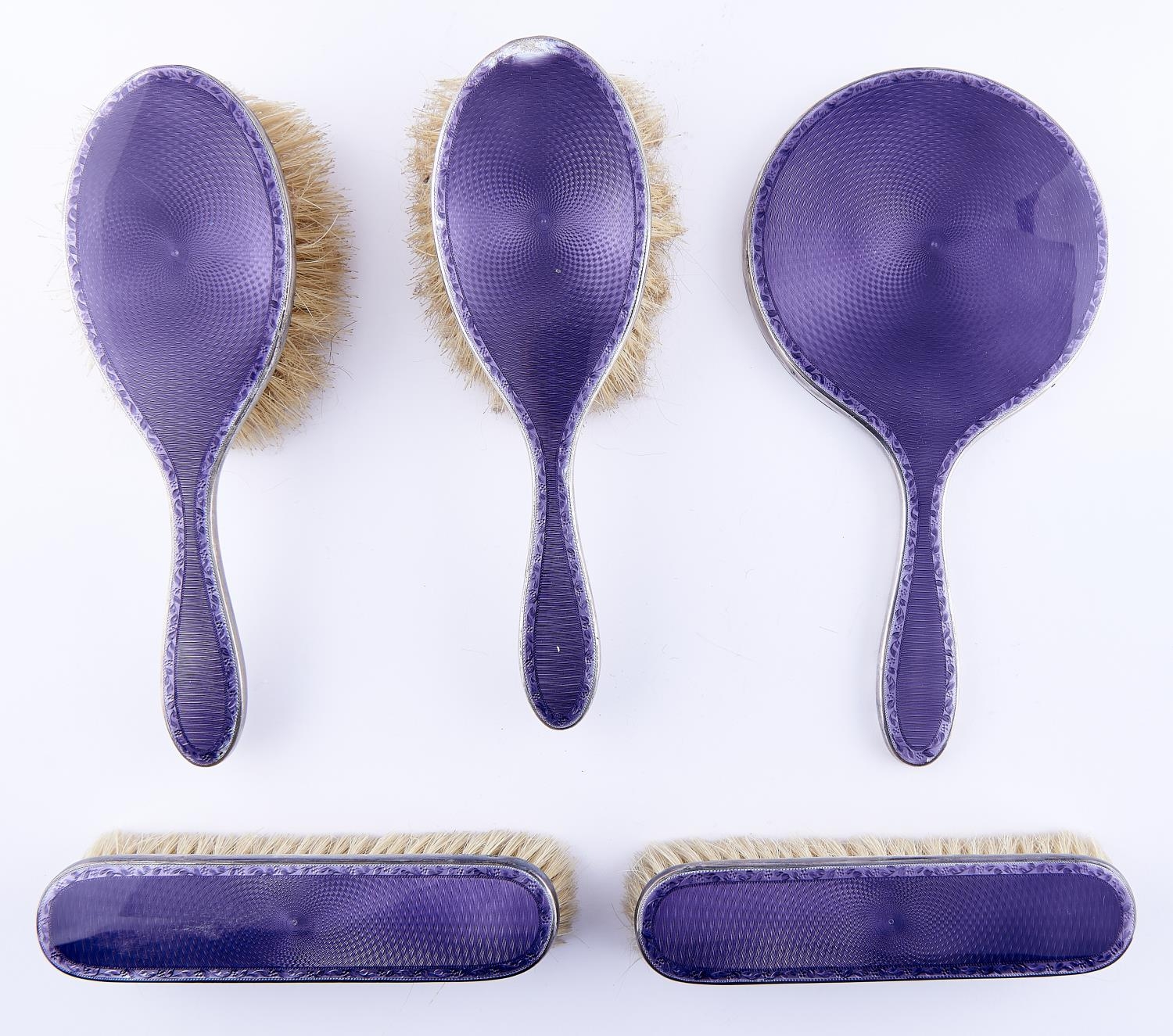 A George V five piece silver and purple guilloche enamel brush set, by William Comyns & Sons Ltd,