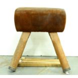 A pine framed vaulting horse, mid 20th c, of conventional form with leather upholstered top and