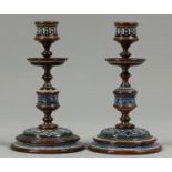 Two Victorian brass and Doulton ware candlesticks, c1895, with three section lacquered brass stem,