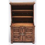 A miniature carved stained wood kitchen dresser, the lower part enclosed by twin panelled doors,