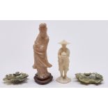 A Chinese soapstone figure of Guanyin, another of a man and a pair of soapstone leaf shaped dishes,