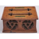 A Victorian gothic oak letter box, the lid with two slots between engraved brass tablets inscribed