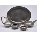 A Liberty & Co four piece Tudric pewter tea service, c1910, oval tray 40.5cm l, marked "TUDRIC",