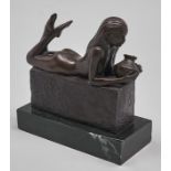 A bronze sculpture of a nude woman holding a jar, late 20th c, on black marble base, 22cm h Good
