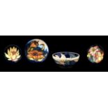 A Moorcroft bowl and three dishes, early 21st c, various designs, bowl 16cm diam, impressed and