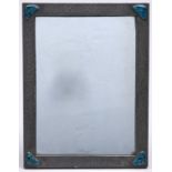 An Arts and Crafts pewter dressing mirror mounted  with contemporary Ruskin type glazed pottery