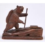 A Swiss anthropomorphic limewood bear novelty ashtray in the form of an alpine hiker, early 20th