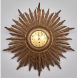 A gold painted wood sunburst wall timepiece, circa mid 20th c, 50cm diam Dusty / dirty but good