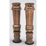 A pair of brass fire hose nozzles
