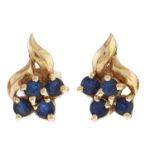 A pair of sapphire ear studs, in the form of a stylised flower, in gold, 1.6g Good condition