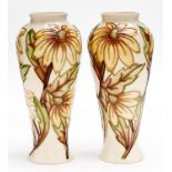 A pair of Moorcroft vases, late 20th c, 21cm h, impressed and painted marks One vase with small chip