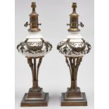 A pair of gilt lacquered metal mounted earthenware  table lamps  in the form of French oil lamps,