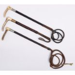 Three stitched or plaited leather covered wood riding crops, c1900, antler handled, one marked