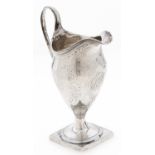 A George III helmet shaped silver cream jug, with reeded handle and rim, engraved with festoons