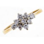 A diamond cluster ring, in gold marked 18K, 2.7g, size M Good condition
