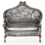 A Continental miniature silver settee, in Louis XV style, the back decorated in relief  with