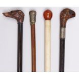 Four Victorian and early 20th c malacca and other canes, two with carved wood hound's head or