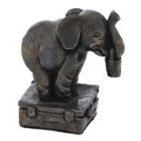 An Elizabeth II silver sculpture of an elephant calf on a suitcase, 95mm h, maker FS, Sheffield