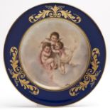 A Vienna style cobalt bordered plate, c1900, printed and painted with three amorini, signed J