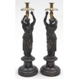 A pair of French brass and bronze candlesticks in the form of classical figures, late 19th c, on