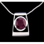 A ruby pendant, of axe head shape in white gold, unmarked, on white gold necklet, marked 750, 6.4g