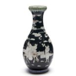 A Chinese garlic necked famille noire vase, 19th / 20th c, painted in reverse with figures, the neck