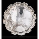 A George V silver salver, on three leaf capped volute feet, 37cm diam, by Walker & Hall Ltd,