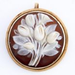 A round cameo brooch-pendant, carved with flowers, mounted in gold, marked K14, 3.7g Cameo in good