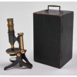 An histological microscope, Bakers, c1887, with round stage and plano concave mirror, objective