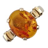An amber ring, in gold marked 585, 3.1g, size N Good condition