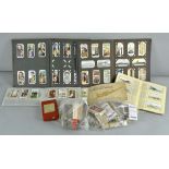 A box of cigarette cards and albums and with some tea cards