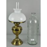 A 20th century brass oil lamp with opaque glass shade and clear funnel,