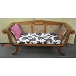 A Biedermeier hardwood bergere sofa with raised back, in ribbed decoration,