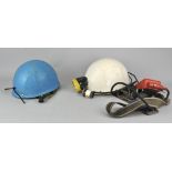 Two caving helmets with a battery pack