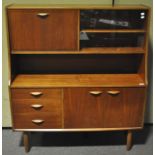 A teak wood highboard drinks cabinet raise on tapered legs,