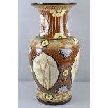 A large ceramic Oriental vase with floral cartouche decoration,