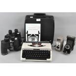 A Bell and Howell 8mm movie camera, a folding Kodak camera,