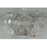 A large collection of mostly pressed glassware, including goblets, footed bowls,