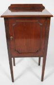 An Edwardian style pot cupboard, of plain form, with panel door, raised on slightly tapered legs,
