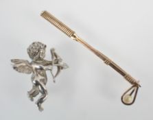 A white metal cupid brooch,