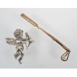 A white metal cupid brooch,