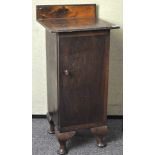 A early 20th century Oak pot cupboard raised upon stubbed cabriolet legs,