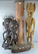 A group of tribal art, to include three figures, a tall drum and another earlier drum,