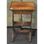An unusual pear wood side table, having single draw to top with book trough undertier,