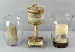 Two glass candle holders with candles an onyx lamp,