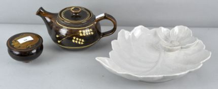 An Art pottery slip decorated tea pot and covered dish, together with a floral form dish,