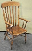 A late 19th century Elm farmhouse chair, having tall rail backrest, squared saddle seat,
