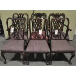 A set of six Chippendale style dining chairs with carved and pierced splats,