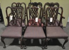 A set of six Chippendale style dining chairs with carved and pierced splats,