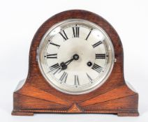 A German (Kienzle) Art Deco oak cased mantle clock, the silvered dial and black numerals,